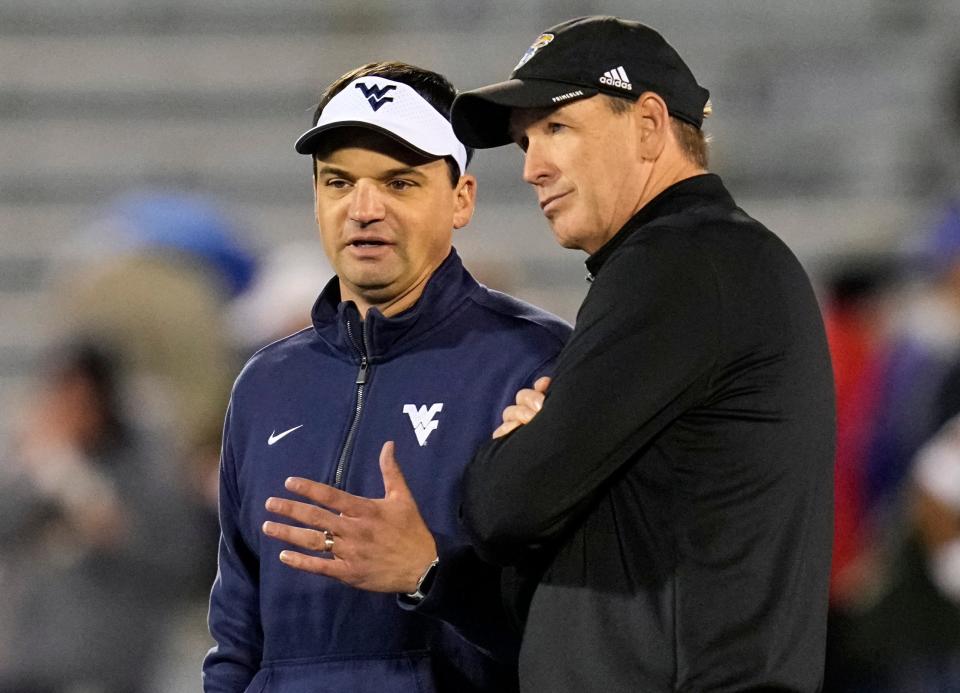 West Virginia head coach Neal Brown talks with Kansas head coach Lance Leipold before a Nov. 27, 2021 game at David Booth Kansas Memorial Stadium between the Mountaineers and Jayhawks.