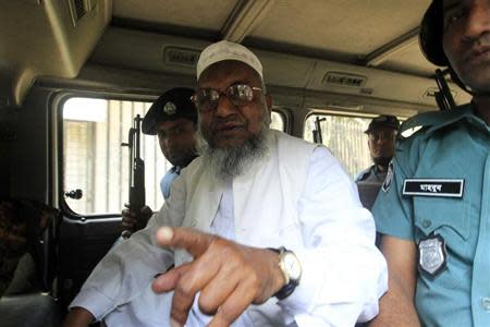 Bangladesh's Jamaat-e-Islami leader Abdul Quader Mollah gestures as he talks from a police van after a war crimes tribunal sentenced him to life imprisonment in Dhaka February 5, 2013. REUTERS/Stringer