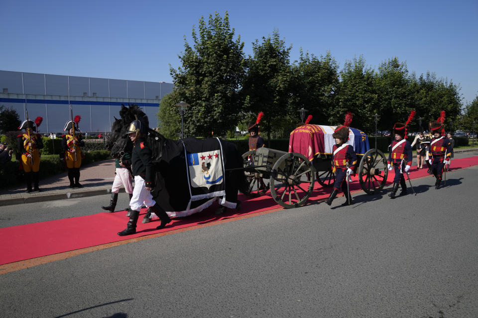 The coffin that contains the remains of Charles-Etienne Gudin, a Napoleon-era French general who died after he was hit by a cannonball near Smolensk during the French invasion of Russia in 1812, is carried on a horse-drawn hearse in Moscow, Russia, Tuesday, July 13, 2021. The remains of the Napoleon-era general whose skeleton was discovered in July 2019 by a team of French and Russian archaeologists under a dance floor in Smolensk, Russia, were repatriated to France Tuesday. (AP Photo/Pavel Golovkin)