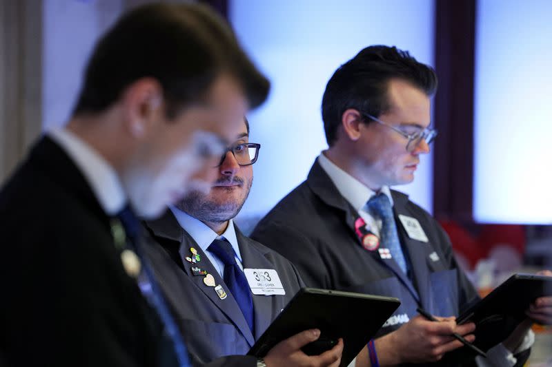 Traders work on the floor of the NYSE in New York