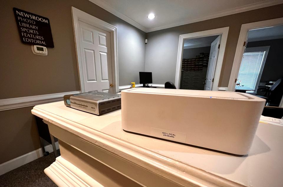 This box in the office of The Fayetteville Observer receives a wireless internet signal from a cellphone service. The silver box to the left of the white box forwards the internet connection to the office computers. An internet speed testing company in August 2023 said T-Mobile has the fastest wireless service in Fayetteville.