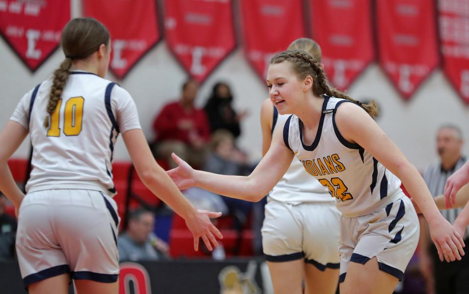 Copley forward Kami Ayoup, facing, celebrates with point guard Evelyn McKnight during the first half of a Division II district semifinal against Woodridge at Elyria High School, Wednesday, Feb. 28, 2024.