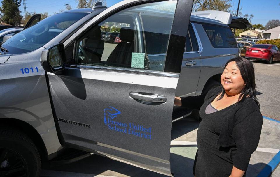 Fort Miller Middle School Community School coordinator Xee Xiong shows the program’s Chevrolet Suburban vehicle, which gives the school flexibility in transporting teachers and students for various activities, while at the Fresno school on Friday, March 8, 2024. CRAIG KOHLRUSS/ckohlruss@fresnobee.com