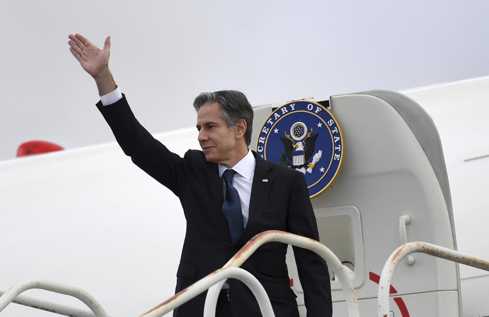 US Secretary of State Antony Blinken waves as he boards his plane at John Lennon Airport in Liverpool, England, Sunday, Dec. 12, 2021 as he departs after attending the G7 foreign ministers summit. (Olivier Douliery/Pool Photo via AP)