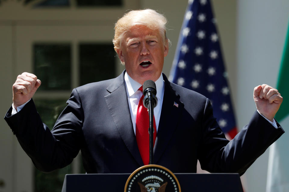 US President Donald Trump speaking outside the White House yesterday (Reuters)