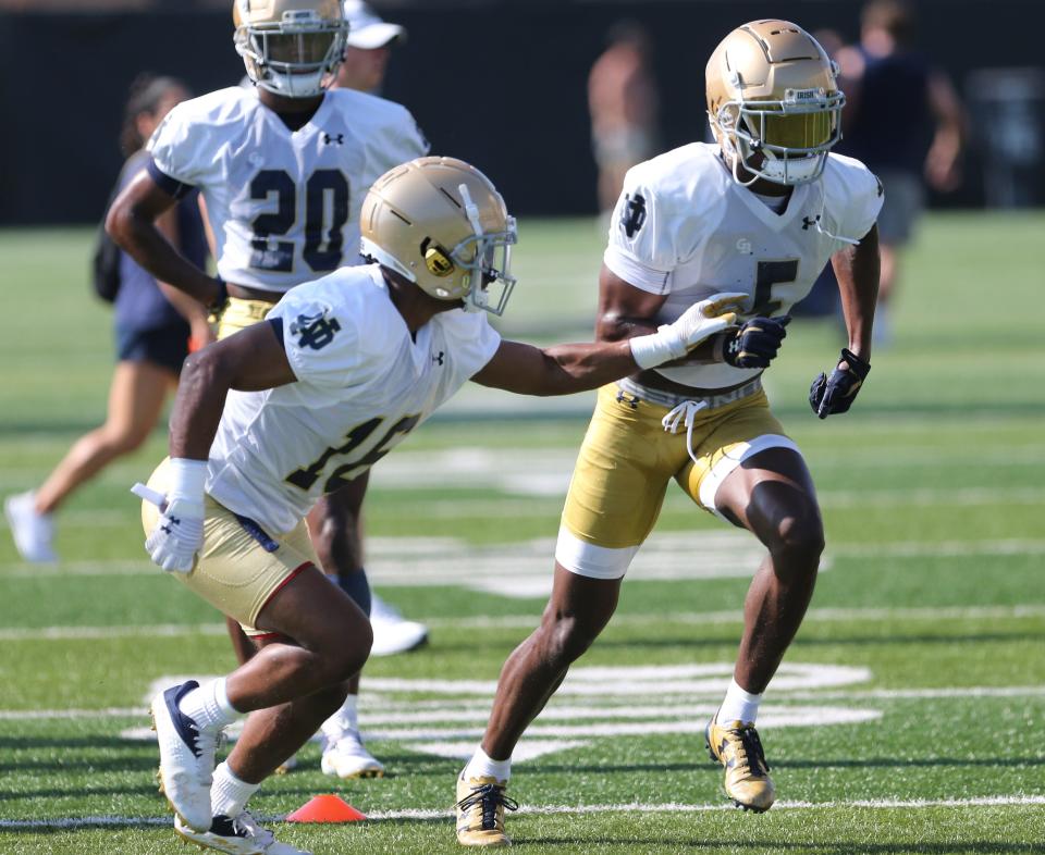 Notre Dame cornerback Cam Hart (5) and cornerback Micah Bell (16) go through a drill as Benjamin Morrison (20) waits his turn during Notre Dame football fall camp Thursday, July 27, 2023, at the LaBar Practice Complex in South Bend.