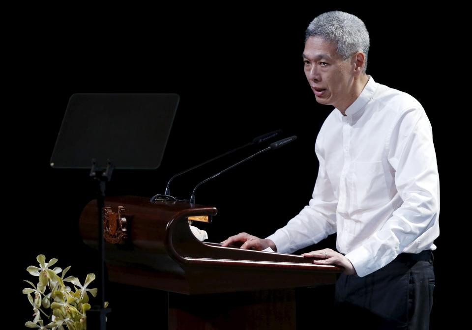 Lee Hsien Yang, son of former leader Lee Kuan Yew, delivers his eulogy during the funeral service at the University Cultural Centre at the National University of Singapore March 29, 2015. Grieving Singaporeans were joined by world leaders on Sunday to pay their final respects to the country&#39;s first prime minister, Lee Kuan Yew, as the nation came to a near-halt to honour its &quot;founding father&quot;. REUTERS/Edgar Su