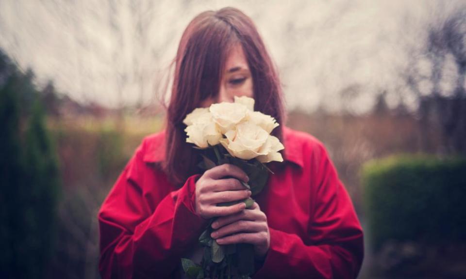 Woman smelling roses