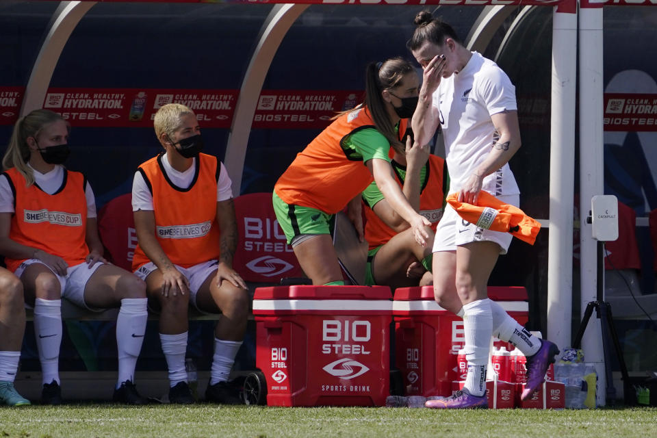 New Zealand defender Meikayla Moore wipes her face as she walks to the bench after being taken out of the game during the first half of the 2022 SheBelieves Cup soccer match against the United States Sunday, Feb. 20, 2022, in Carson, Calif. (AP Photo/Mark J. Terrill)