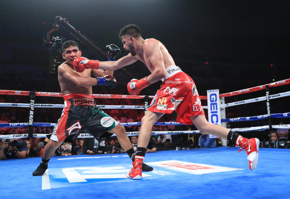 WBC super lightweight champion Jose Ramirez (R) cracks challenger Antonio Orozco with a stiff right hand Friday at the Save Mart Center in Fresno, California. (MTop Rank)