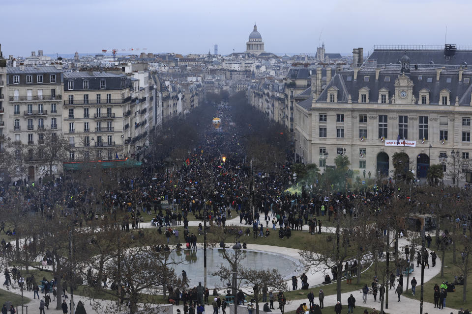 Protesters march during a demonstration, Tuesday, March 7, 2023 in Paris. Hundreds of thousands of demonstrators across France took part Tuesday in a new round of protests and strikes against the government's plan to raise the retirement age to 64, in what unions hope will be their biggest show of force against the proposal. (AP Photo/Aurelien Morissard)