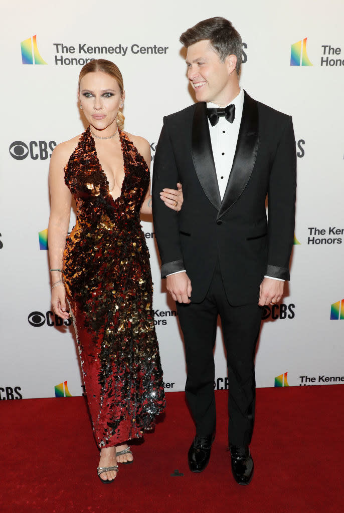 dressed in a classic tux, Colin can't take his eyes off of Scarlett, who's wearing a stunning, sequined halter dress with a plunging neckine