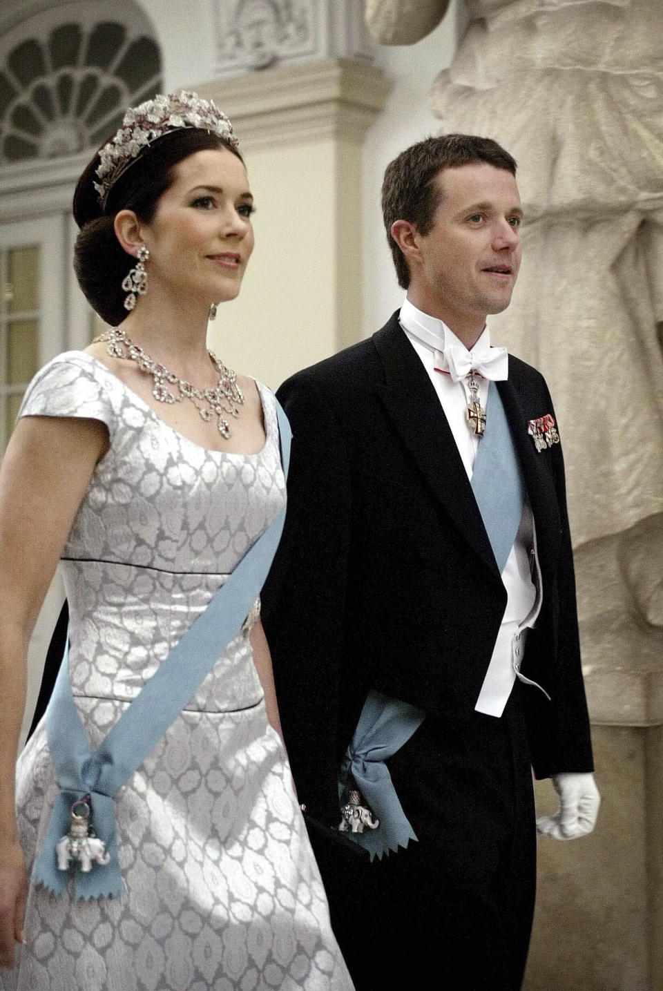 FILE - Mary Donaldson, soon to be crown princess, and Danish Crown Prince Frederik arrive at Christiansborg castle Wednesday May 11, 2004, to attend the banquet for Danish dignitaries kicking off official wedding celebrations in Denmark. As a teenager, Crown Prince Frederik felt uncomfortable being in the spotlight, and pondered whether there was any way he could avoid becoming king. All doubts have been swept aside as the 55-year-old takes over the crown on Sunday, Jan. 14, 2024 from his mother, Queen Margrethe II, who is breaking with centuries of Danish royal tradition and retiring after a 52-year reign. (Thomas Wilmann/Ritzau Scanpix via AP, File)