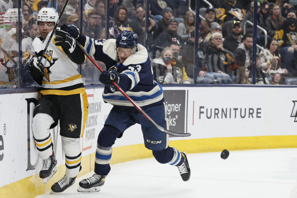 Columbus Blue Jackets' Gabriel Carlsson, right, checks Pittsburgh Penguins' Dominik Simon during the first period of an NHL hockey game Sunday, Feb. 27, 2022, in Columbus, Ohio. (AP Photo/Jay LaPrete)