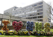 Flowers are arranged in the shape of letters outside St Thomas' Hospital in central London as British Prime Minister Boris Johnson is in intensive care fighting the coronavirus in London, Tuesday, April 7, 2020. Johnson was admitted to St Thomas' hospital in central London on Sunday after his coronavirus symptoms persisted for 10 days. Having been in hospital for tests and observation, his doctors advised that he be admitted to intensive care on Monday evening. The new coronavirus causes mild or moderate symptoms for most people, but for some, especially older adults and people with existing health problems, it can cause more severe illness or death.(AP Photo/Kirsty Wigglesworth)