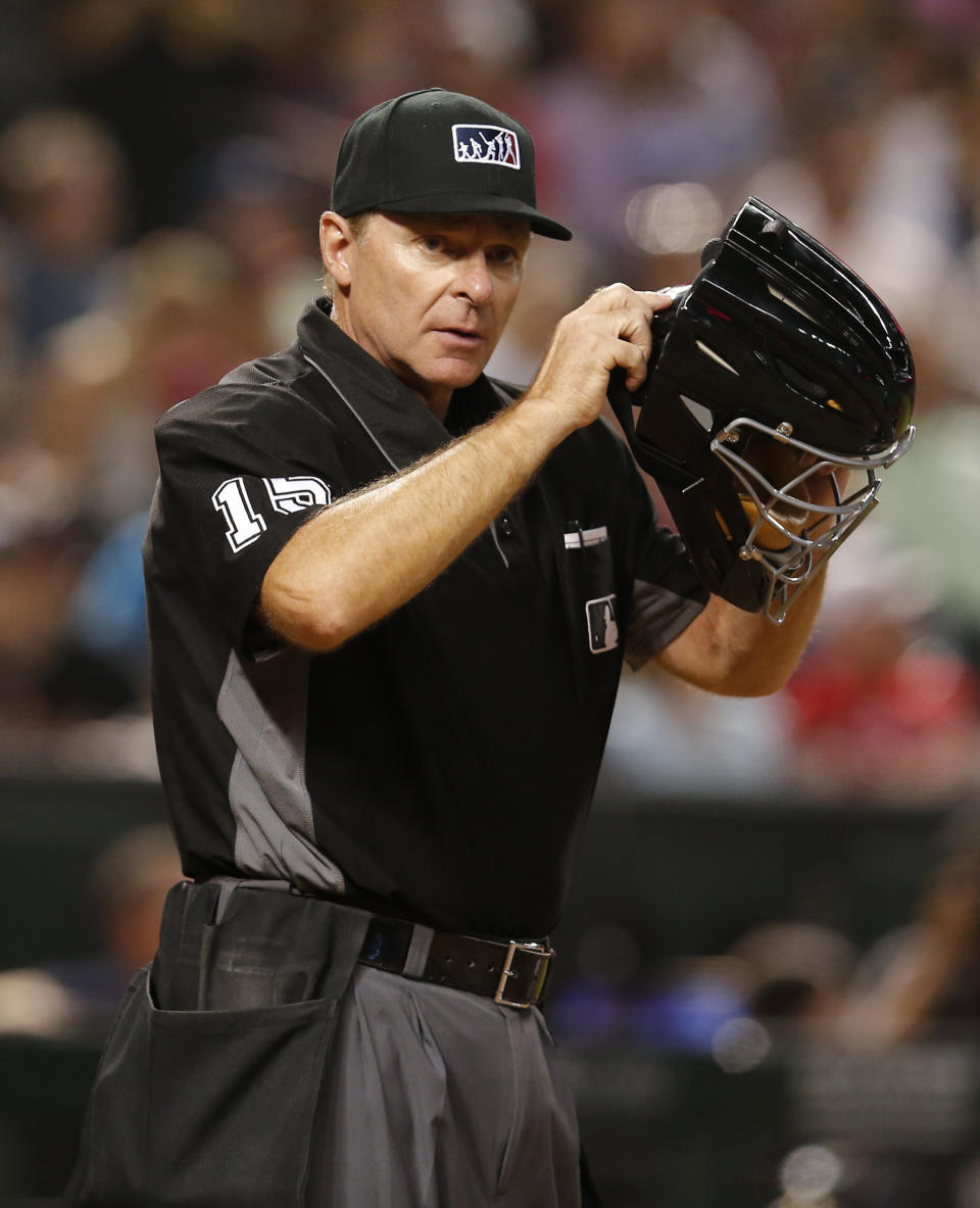 FILE - Major League Baseball umpire Ed Hickox (15) is shown in the first inning during a baseball game between the Arizona Diamondbacks and the Seattle Mariners, Friday, Aug. 24, 2018, in Phoenix. Jeff Nelson and Ed Hickox are retiring as umpires and were replaced Monday, Feb. 12, 2024, on the major league staff by Ryan Wills and Clint Vondrak.(AP Photo/Rick Scuteri, File)