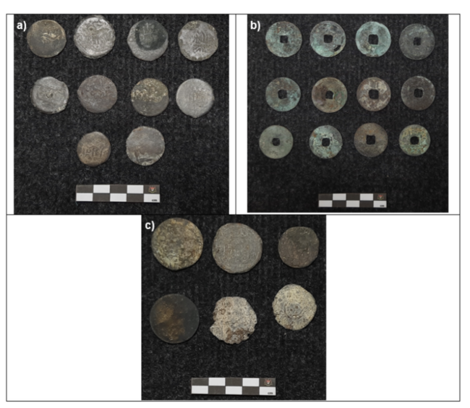 A collection of coins, including ones from China and Portugal, discovered at the site