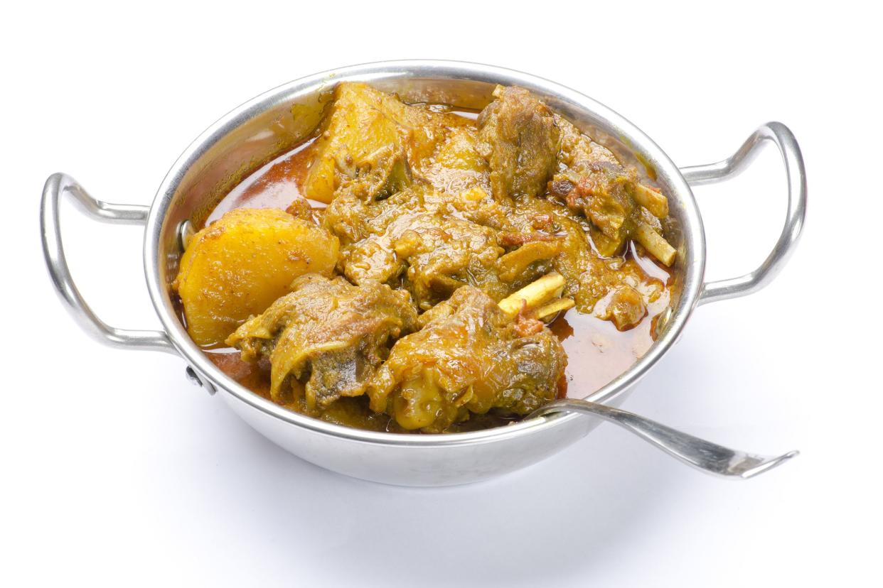 Jamaican Curry Goat in silver serving bowl