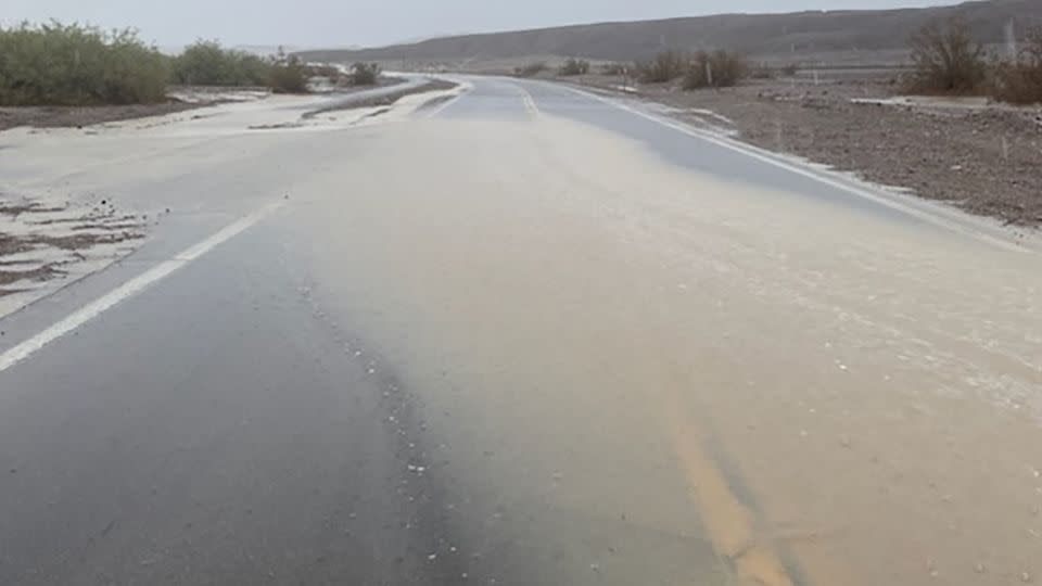 Floodwaters from Tropical Storm Hilary cover a road in Death Valley National Park on Sunda. - Death Valley National Park Service