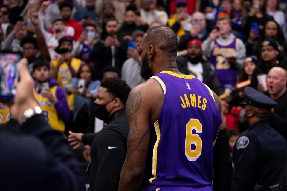 Los Angeles Lakers forward LeBron James walks off the court after being ejected from Sunday&#39;s game against the Detroit Pistons.