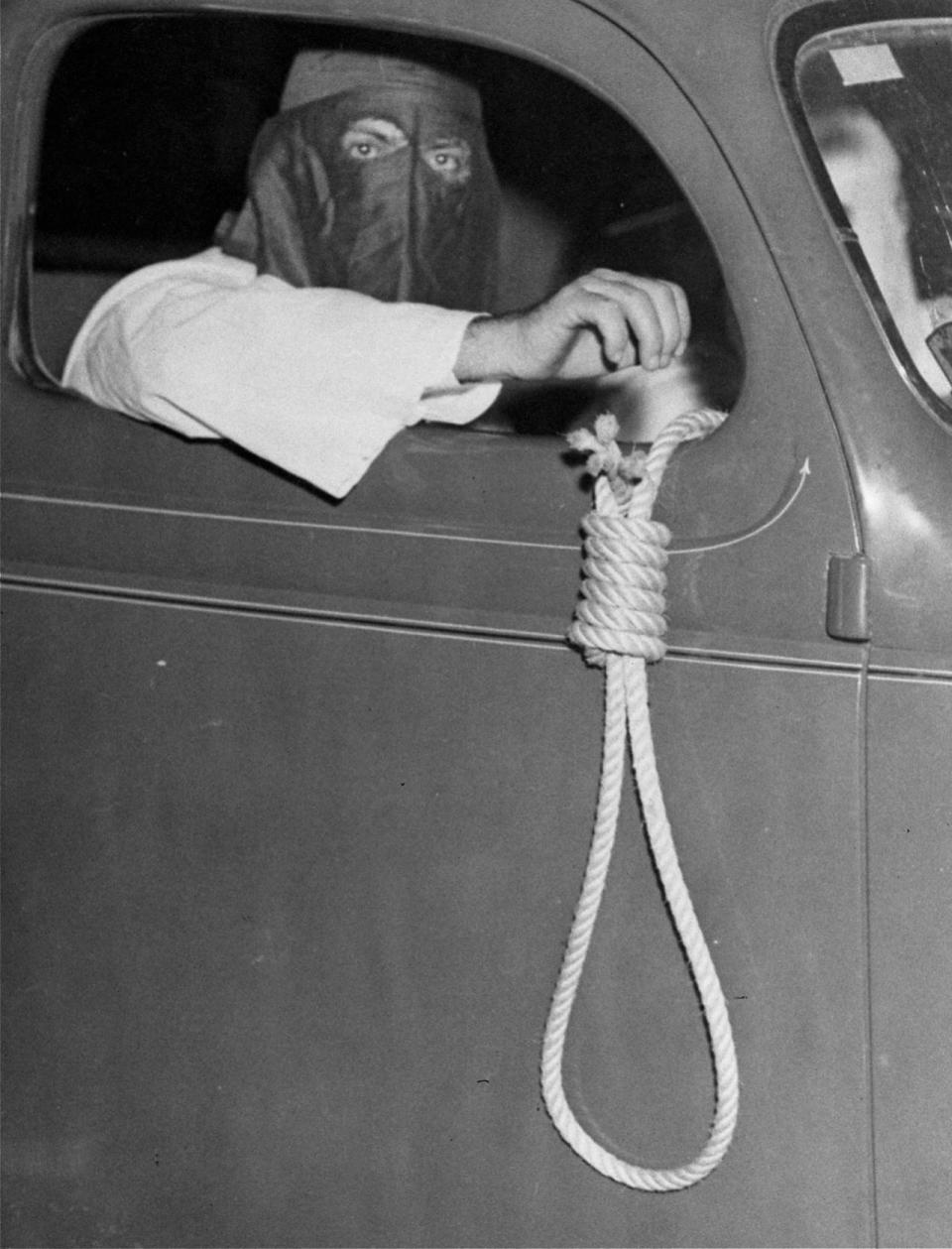 <p>A noose dangles from an automobile carrying Ku Klux Klan members, warning blacks to stay away from polling places for a municipal primary election in Miami. In spite of the threats, over 600 black voters cast their ballots, May 3, 1939. (Photo: AP) </p>