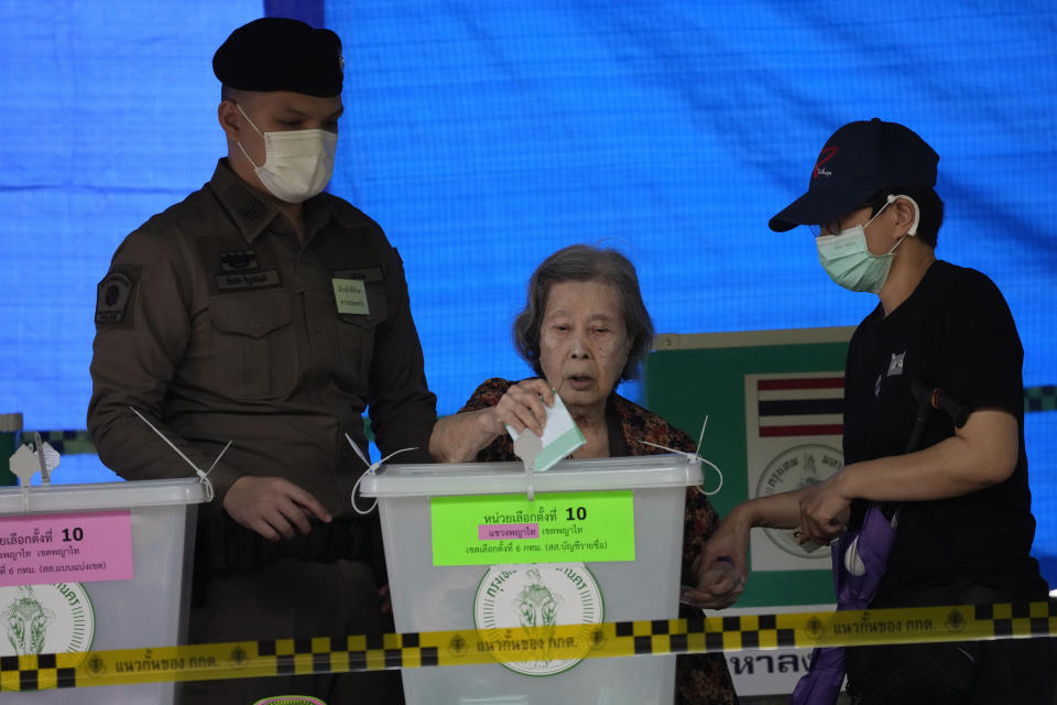 A woman casts her vote at a polling station in Bangkok, Thailand, Sunday, May 14, 2023. Voters in Thailand were heading to the polls on Sunday in an election touted as a pivotal chance for change, eight years after incumbent Prime Minister Prayuth Chan-ocha first came to power in a 2014 coup. (AP Photo/Sakchai Lalit)