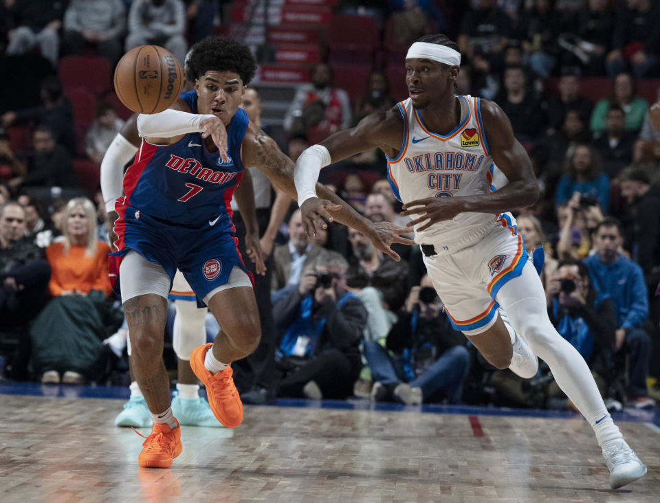 Oklahoma City Thunder's Shai Gilgeous-Alexander, right, and Detroit Pistons' Killian Hayes (7) vie for the ball during the first half of an NBA preseason basketball game Thursday, Oct. 12, 2023, in Montreal. (Christinne Muschi/The Canadian Press via AP)