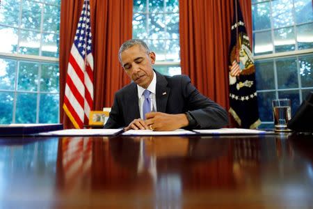U.S. President Barack Obama signs into law S. 337: FOIA Improvement Act of 2016 and S. 2328: Puerto Rico Oversight, Management and Economic Stability Act at the Oval Office of the White House in Washington, U.S., June 30, 2016. REUTERS/Carlos Barria/File Photo