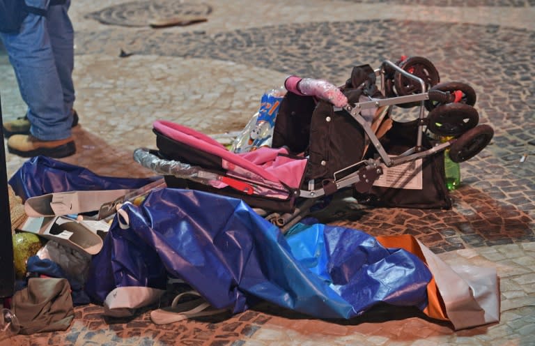 A discarded pram is seen at the scene of a car crash which killed a baby and injured 17 others