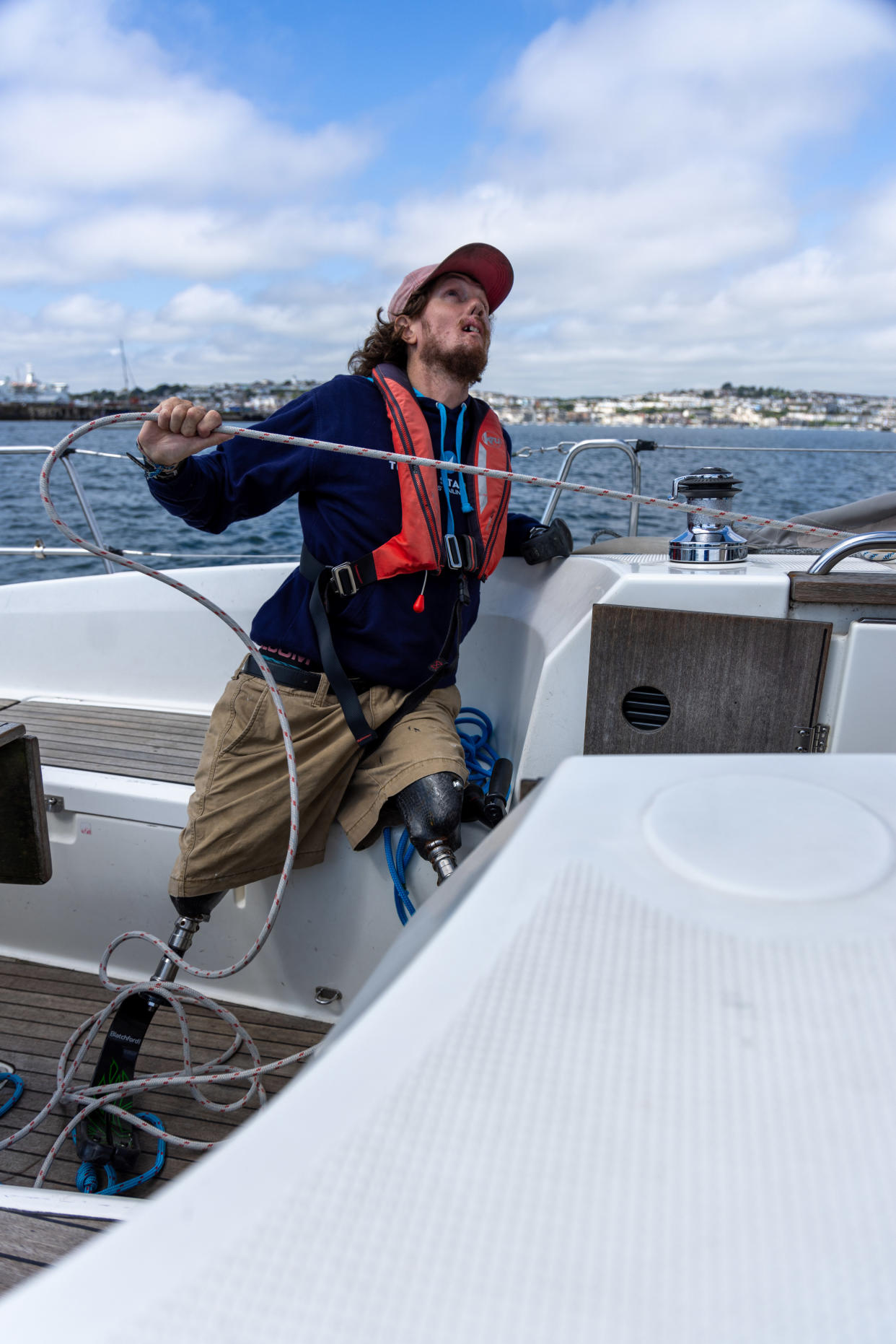 Craig Wood on his sailing boat pulling a line of rope 