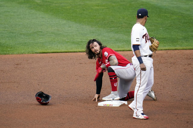 Cincinnati Reds' Eugenio Suarez blows a bubble with his gum as he