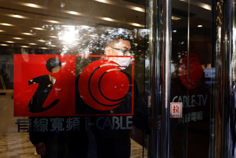 A man leaves i-Cable TV building after about 100 members of staff have been laid off in Hong Kong