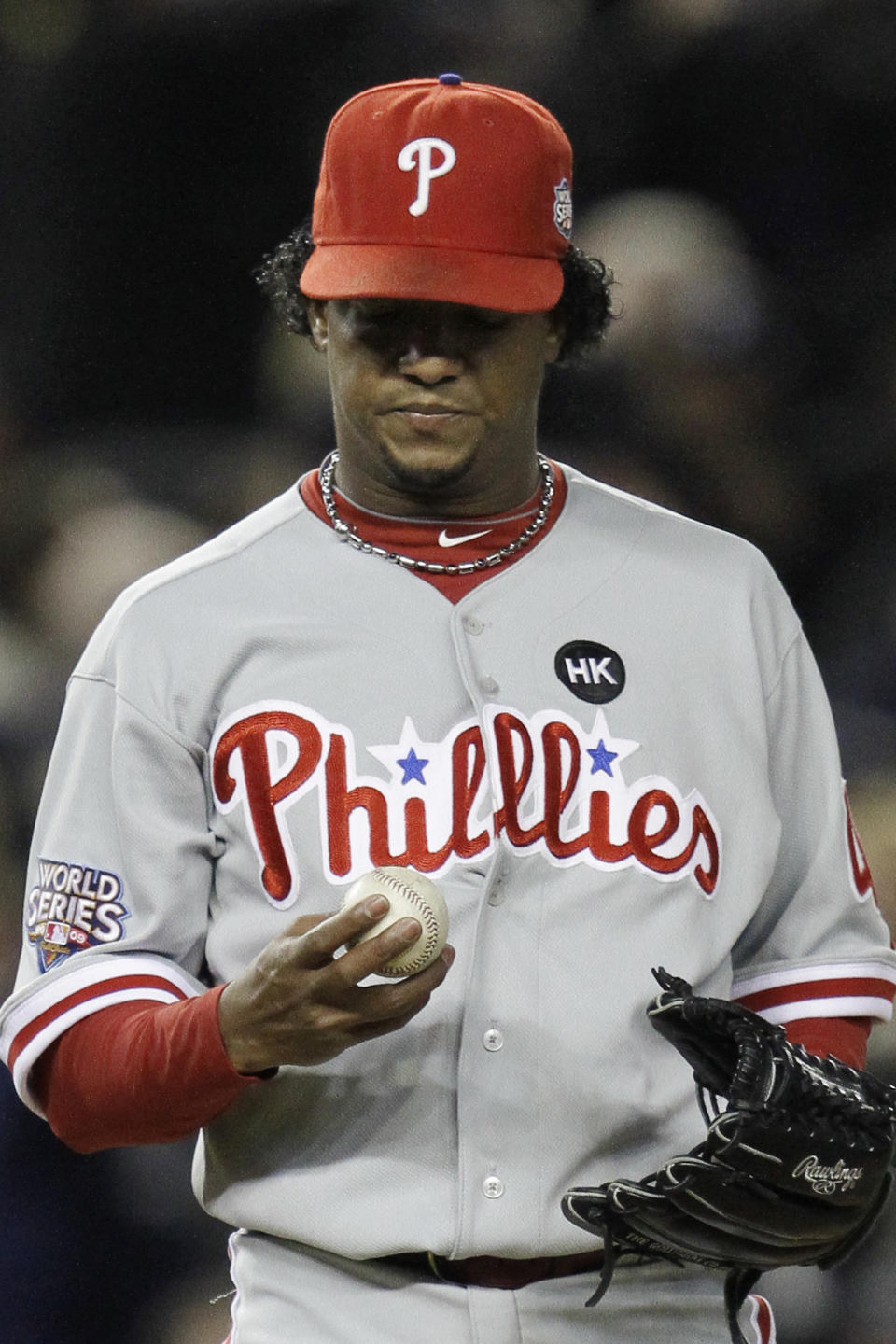 FILE - In this Nov. 4, 2009, file photo, Philadelphia Phillies' Pedro Martinez looks at his ball after giving up a two-run home run to New York Yankees' Hideki Matsui during the second inning of Game 6 of the Major League Baseball World Series in New York. The Phillies lost to the New York Yankees in six games and Martinez went 0-2 in two starts against the Yankees with a 6.30 ERA _ but has long said he was sick in his Game 6 start at Yankee Stadium and always wished he could have that one back. (AP Photo/David J. Phillip, File)