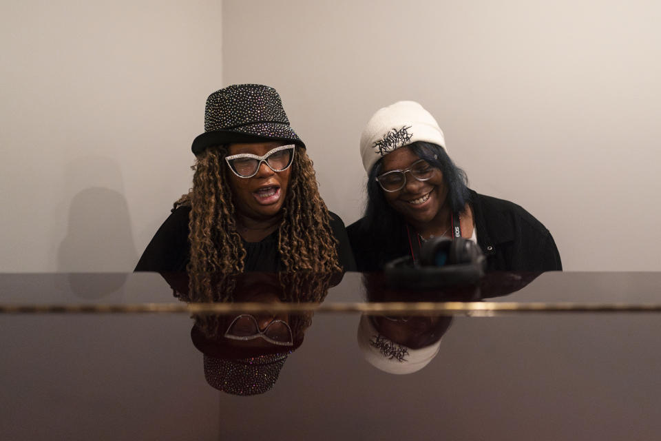 Beatrice X Johnson, also known as Auntie Bee, and La'Nya Friday, right, sing together while playing the piano in a mansion purchased by the Black Lives Matter Global Network Foundation during a welcome dinner for the annual Families United 4 Justice Network Conference hosted by the foundation in the Studio City neighborhood of Los Angeles, Thursday, Sept. 28, 2023. La'Nya's father, Colby Friday, was fatally shot by a Stockton, Calif., police officer in 2016, according to the family. (AP Photo/Jae C. Hong)