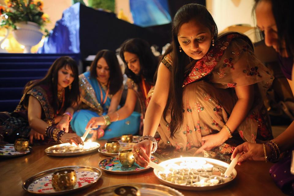 LONDON, ENGLAND - NOVEMBER 14: Scented candles are lit before being offered to wellwishers during a ceremony as Sadhus and Hindus celebrate Diwali at the BAPS Shri Swaminarayan Mandir on November 14, 2011 in London, England. Diwali, which marks the start of the Hindu New Year, is being celebrated by thousands of Hindu men women and children in the Neasden mandir, which was the first traditional Hindu temple to open in Europe. (Photo by Dan Kitwood/Getty Images)