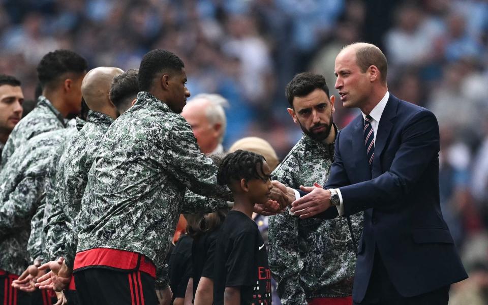 Prince William shakes hands with Marcus Rashford