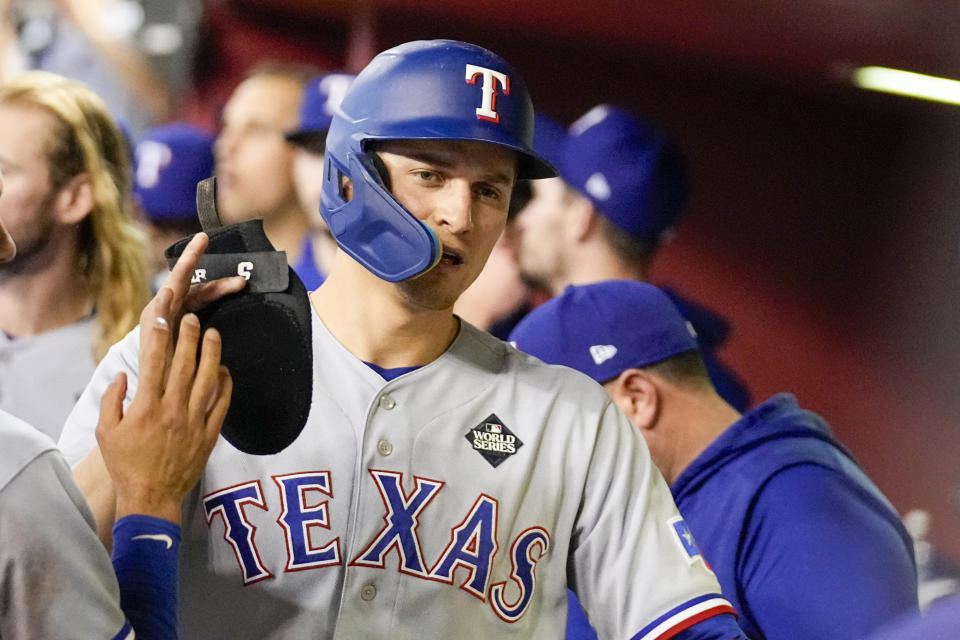 Texas Rangers' Corey Seager celebrates in the dugout after a double against the Arizona Diamondbacks during the ninth inning in Game 4 of the baseball World Series Tuesday, Oct. 31, 2023, in Phoenix. (AP Photo/Brynn Anderson)