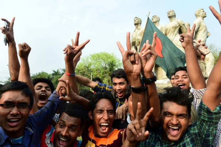 Bangladeshi cricket fans at a university campus in Dhaka celebrate their national team's victory over Sri Lanka on March 19, 2017