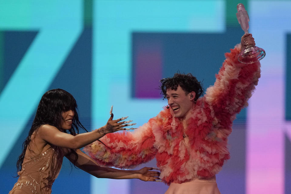 Nemo of Switzerland, who performed the song The Code, celebrates with last year's winner Loreen of Sweden after winning the Grand Final of the Eurovision Song Contest in Malmo, Sweden, Saturday, May 11, 2024. (AP Photo/Martin Meissner)