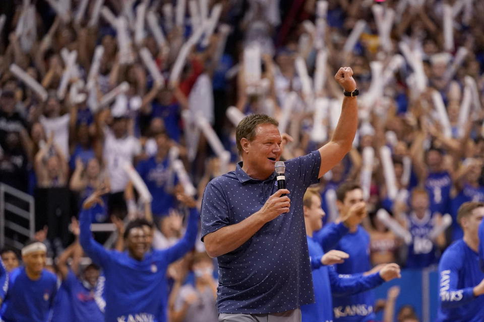 FILE - Kansas head coach Bill Self cheers with the crowd during Late Night at the Phog, the school's annual NCAA college basketball kickoff, at Allen Fieldhouse in Lawrence, Kan., in this Friday, Oct. 1, 2021, file photo. Kansas is No. 3 in The Associated Press Top 25 men's college basketball poll released Monday, Oct. 18, 2021. (AP Photo/Charlie Riedel, File)