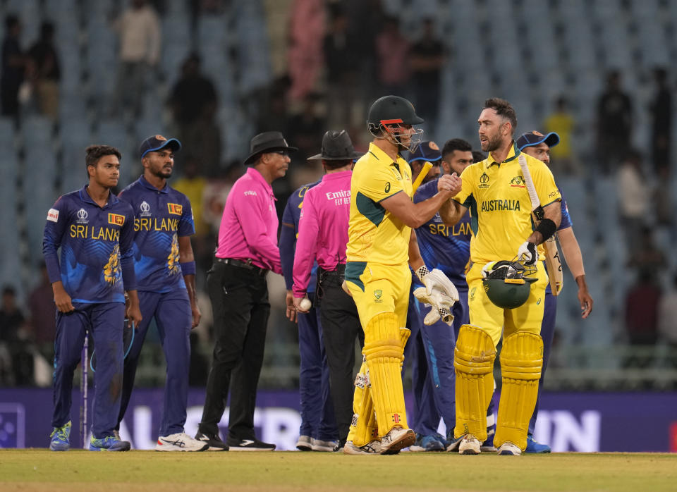 Australia's Marcus Stoinis and Glenn Maxwell congratulate each other after wining against Sri Lanka by 5 wickets during the ICC Men's Cricket World Cup in Lucknow, India, Monday, Oct. 16, 2023. (AP Photo/Aijaz Rahi)