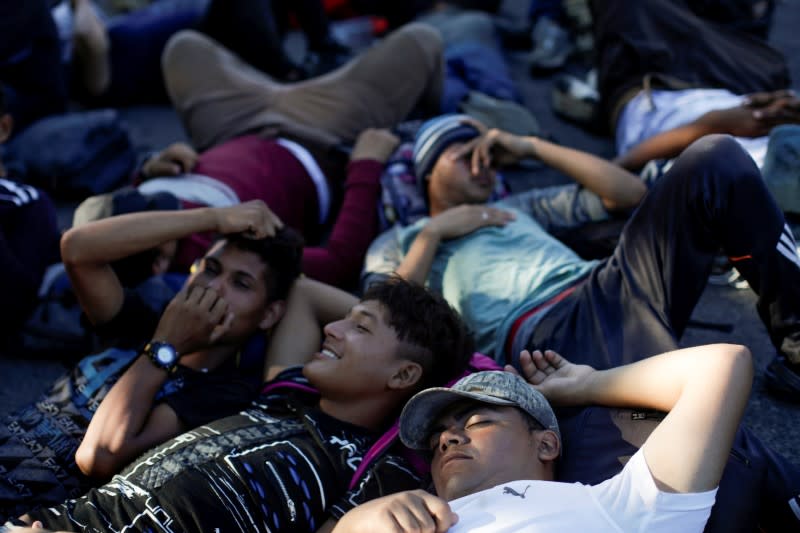 Migrants, mainly from Central America and marching in a caravan, rest on a road near Ignacio Zaragoza, Chiapas