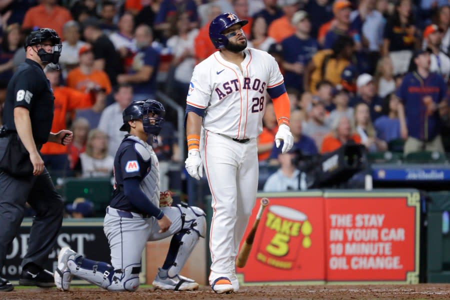 Houston Astros’ Jon Singleton, right, drops his bat as he watches his three run home run in front of Cleveland Guardians catcher <a class="link " href="https://sports.yahoo.com/mlb/players/11296/" data-i13n="sec:content-canvas;subsec:anchor_text;elm:context_link" data-ylk="slk:Bo Naylor;sec:content-canvas;subsec:anchor_text;elm:context_link;itc:0">Bo Naylor</a>, centerm and umpire Stu Scheurwater, left, during the fourth inning of a baseball game Tuesday, April 30, 2024, in Houston. (AP Photo/Michael Wyke)