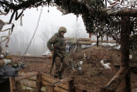 A Ukrainian soldier takes position on the front line at the town of Novoluhanske in the Donetsk region, Ukraine, Monday, Dec. 9 2019. A long-awaited summit in Paris on Monday aims to find a way to end the war in eastern Ukraine, a conflict that after five years and 14,000 lives lost has emboldened the Kremlin and reshaped European geopolitics. (AP Photo/Vitali Komar)