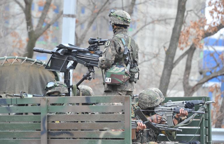 South Korean soldiers stand guard at a check point during a drill near the border with North Korea, in Paju, on March 28, 2013