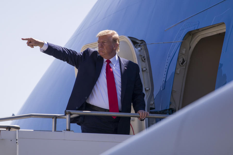 President Donald Trump points while boarding Air Force One as he departs General Mitchell International Airport, Friday, July 12, 2019, in Milwaukee. (AP Photo/Alex Brandon)