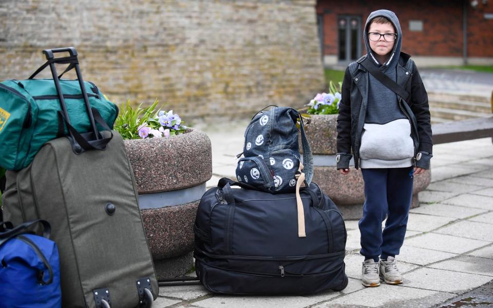 Eight-year-old Ruslan, a refugee from Kharkiv, arrives at the border station in Narva, Estonia - Sergei Stepanov for The Telegraph