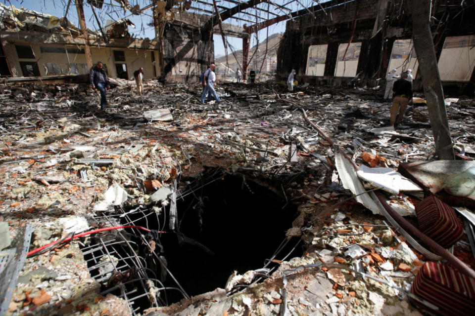 <p>Journalists and policemen inspect the secene at the community hall where Saudi-led warplanes struck a funeral in Sanaa, the capital of Yemen on Oct. 9, 2016. (Khaled Abdullah/Reuters)</p>