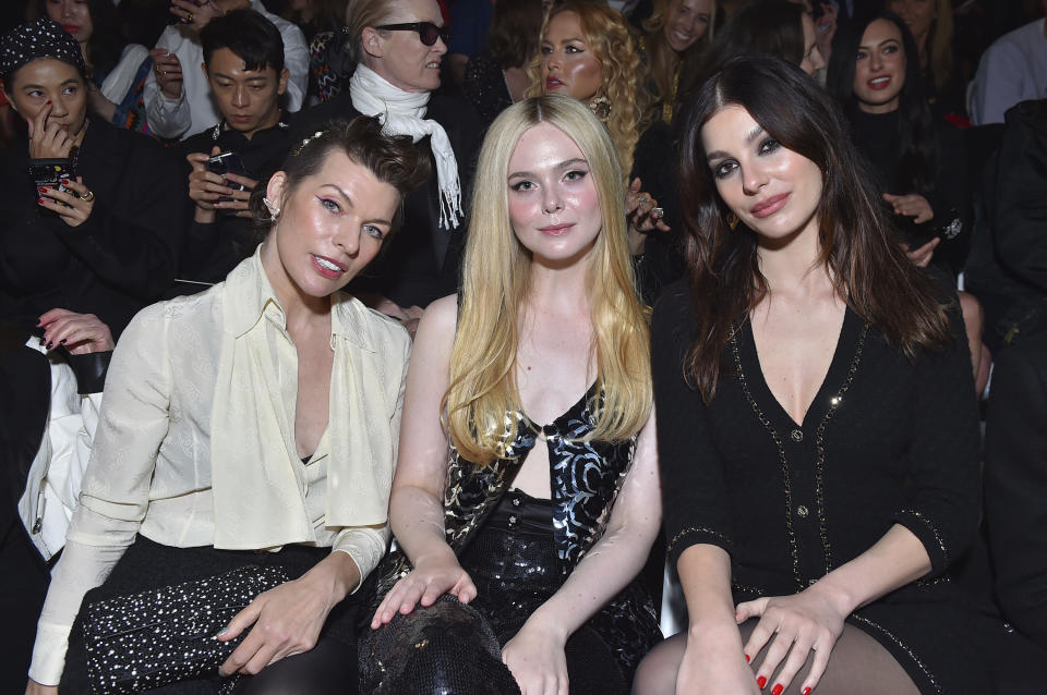 Milla Jovovich, from left, Elle Fanning and Camila Morrone attend the Chanel Cruise 2023/2024 Fashion Show on Tuesday, May 9, 2023, at Paramount Studios in Los Angeles. (Photo by Jordan Strauss/Invision/AP)