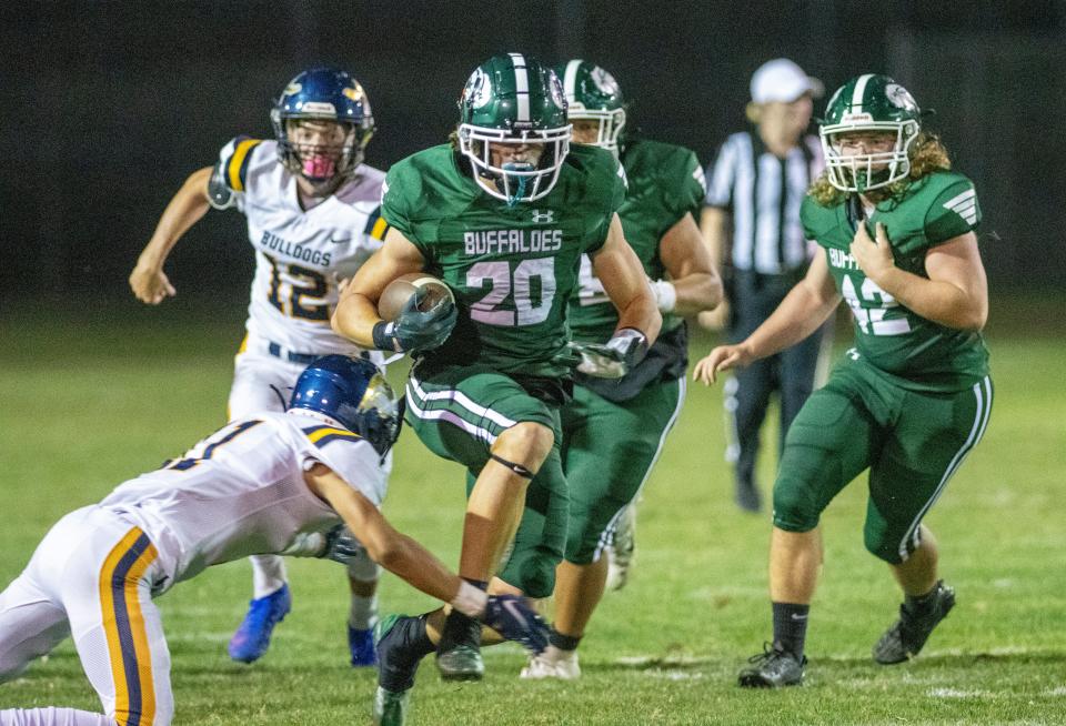 Manteca's Blake Nichelson runs through a huge hole against Turlock High on Sept. 9. Manteca led 35-22 at the half.